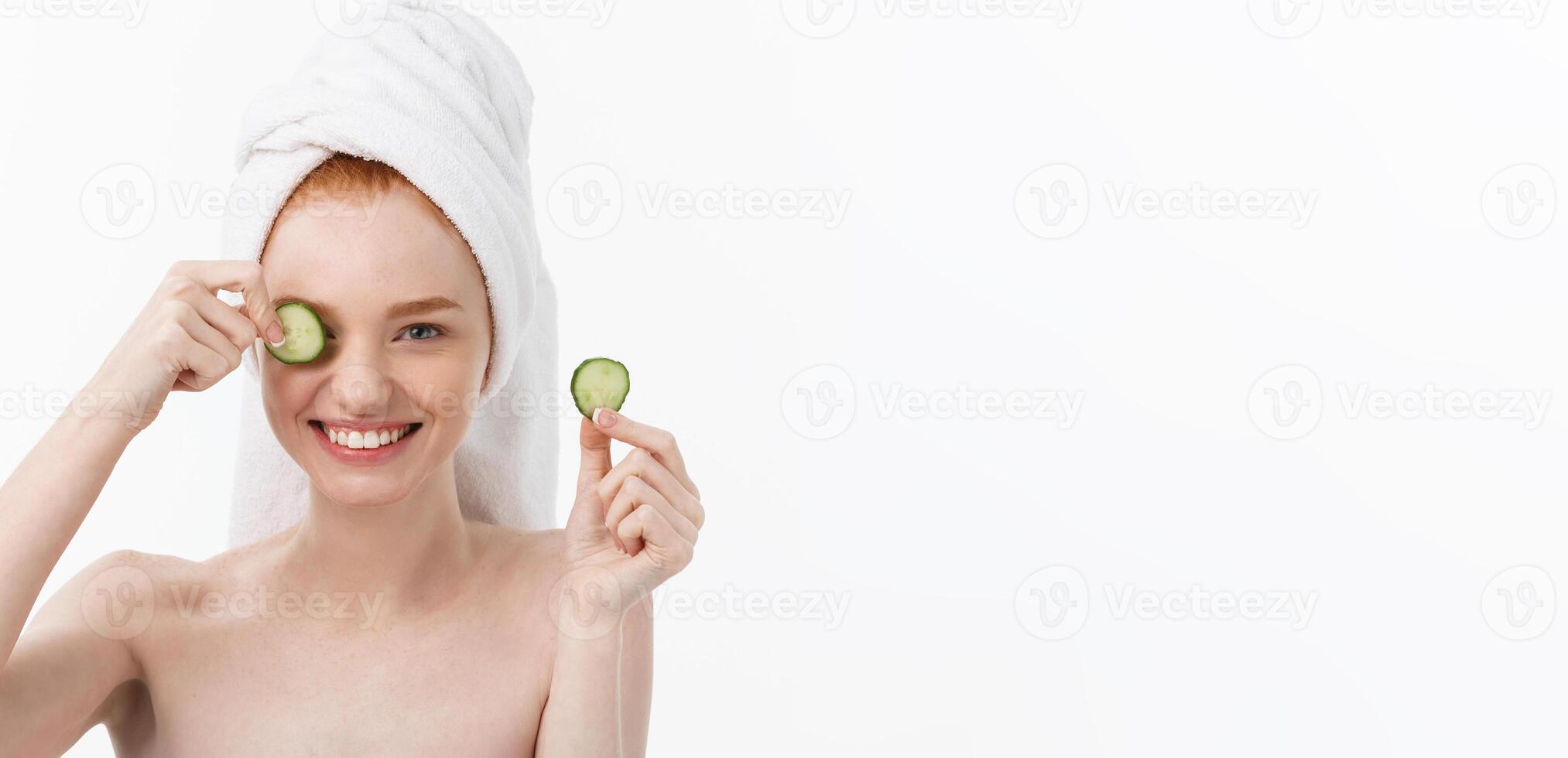 Attractive Young Woman with beautiful clean skin. White mask and cucumbers. Beauty treatments and cosmetology spa therapy. White background photo
