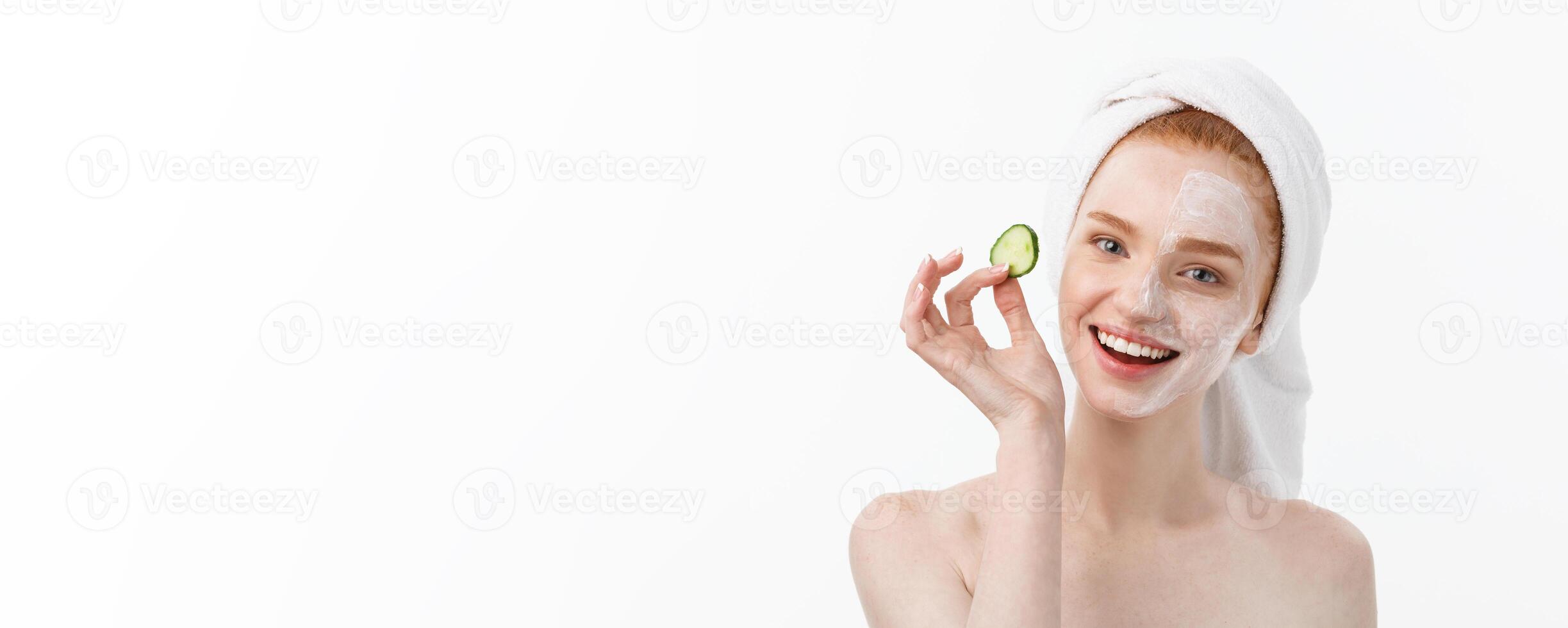 Attractive Young Woman with beautiful clean skin. White mask and cucumbers. Beauty treatments and cosmetology spa therapy. White background photo