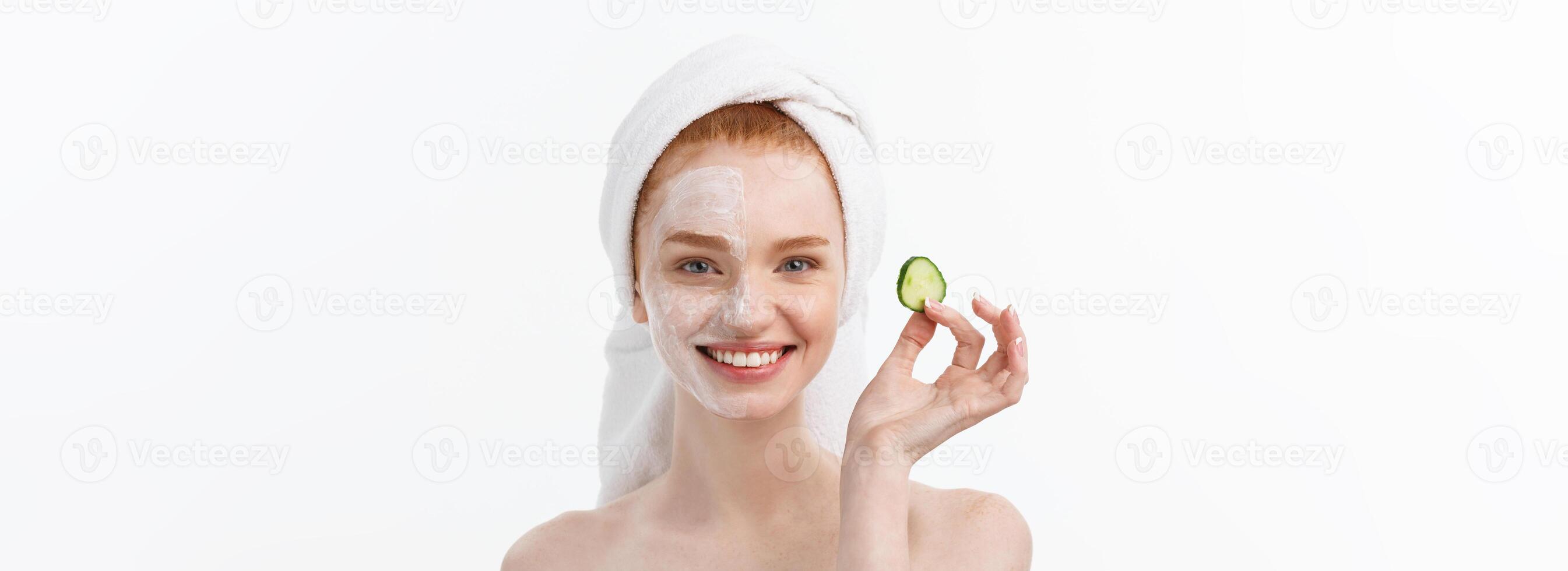 Attractive Young Woman with beautiful clean skin. White mask and cucumbers. Beauty treatments and cosmetology spa therapy. White background photo