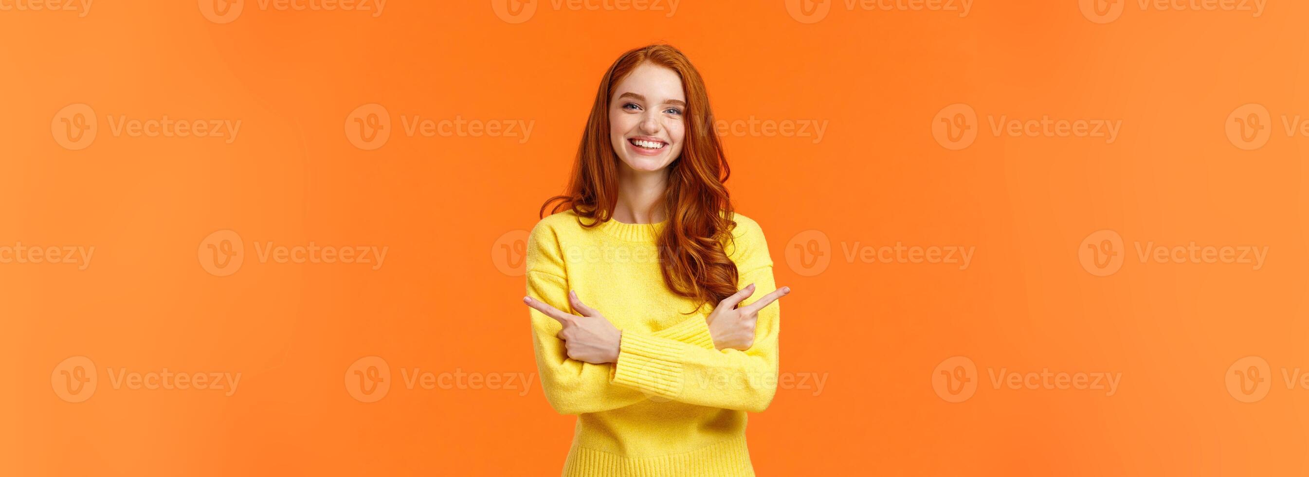 Choices, shopping, winter holidays concept. Cute smiling redhead girl with curly red hair, yellow sweater, pointing sideways, cross hands over chest showing left and right product, event promo photo