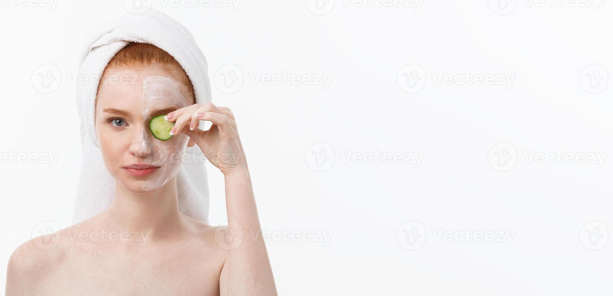 Attractive Young Woman with beautiful clean skin. White mask and cucumbers. Beauty treatments and cosmetology spa therapy. White background photo