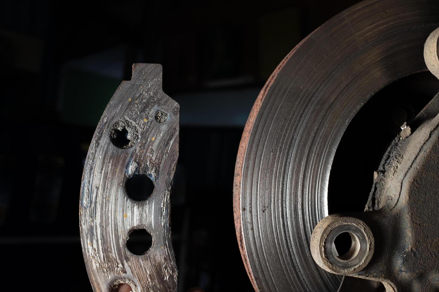 Brake pads expired.The car brake disc is broken.The car brake system is broken and needs to be repaired. photo