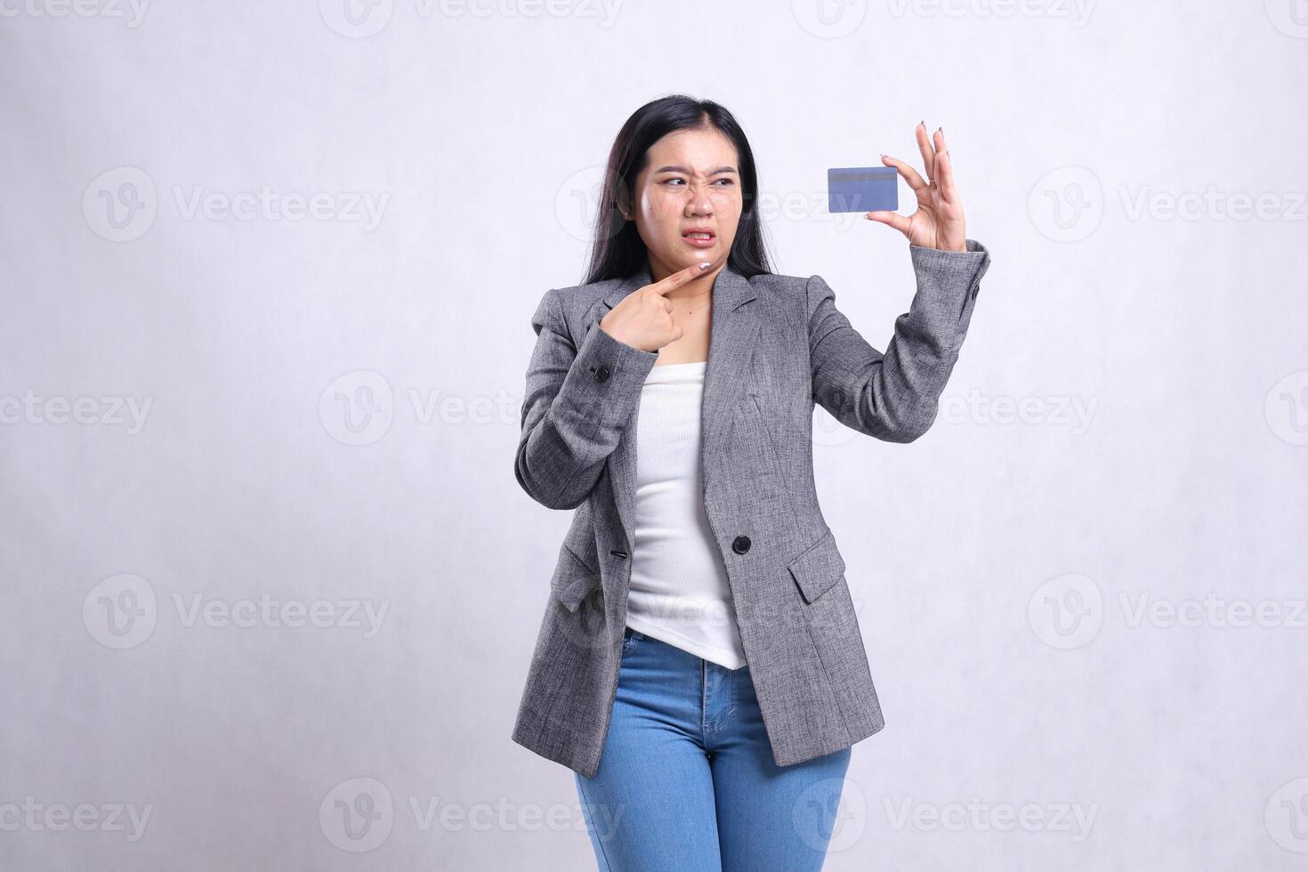 gesture adult office woman asia hate pointing, looking and holding debit credit card wearing grey suit standing isolated on white background. for advertising content, lifestyle, finance, transaction photo