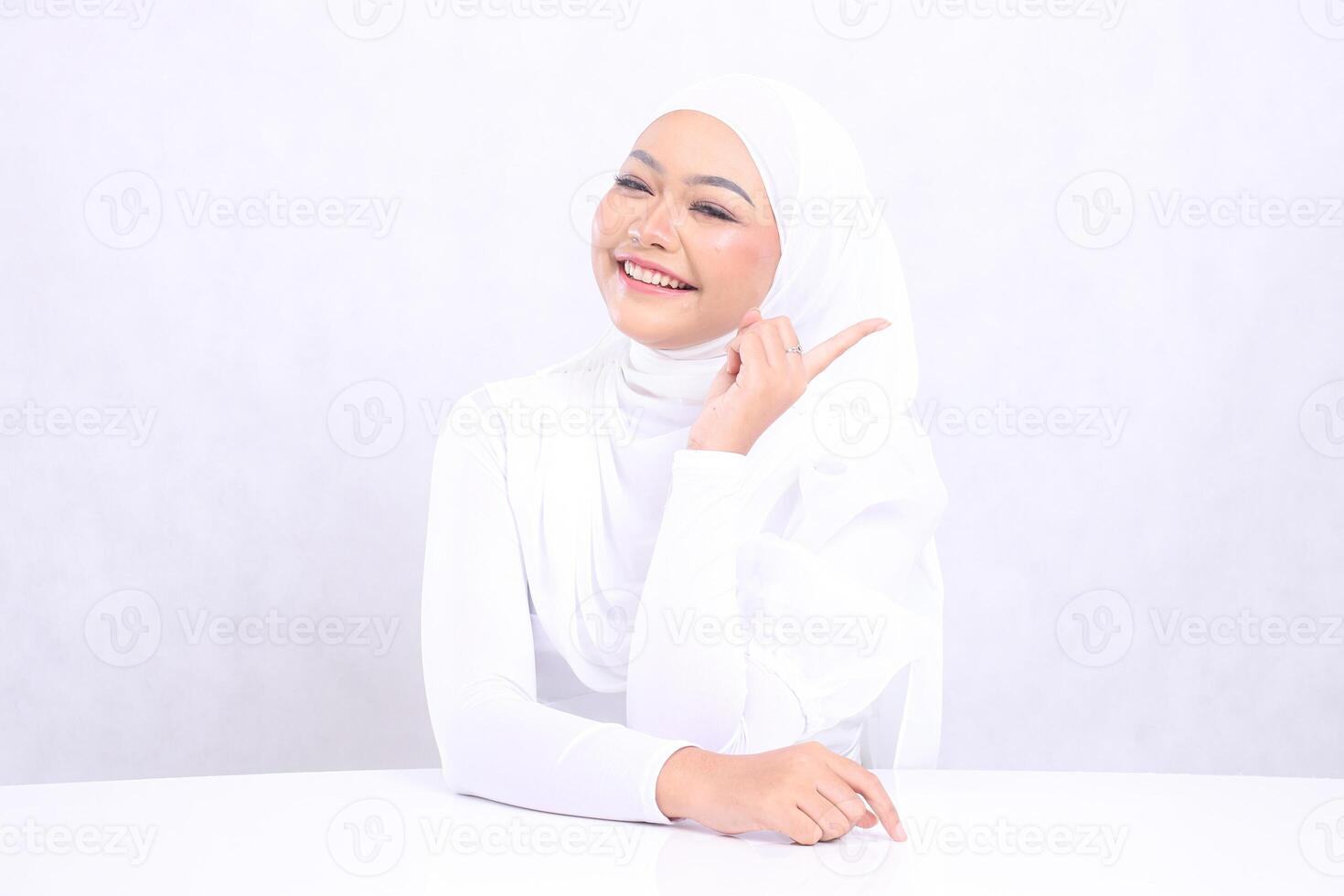 Beauty mature woman laughing freely to the front pointing left with bright, glowing and smooth skin tone. studio on isolated white background for skin care concept. beauty and health photo