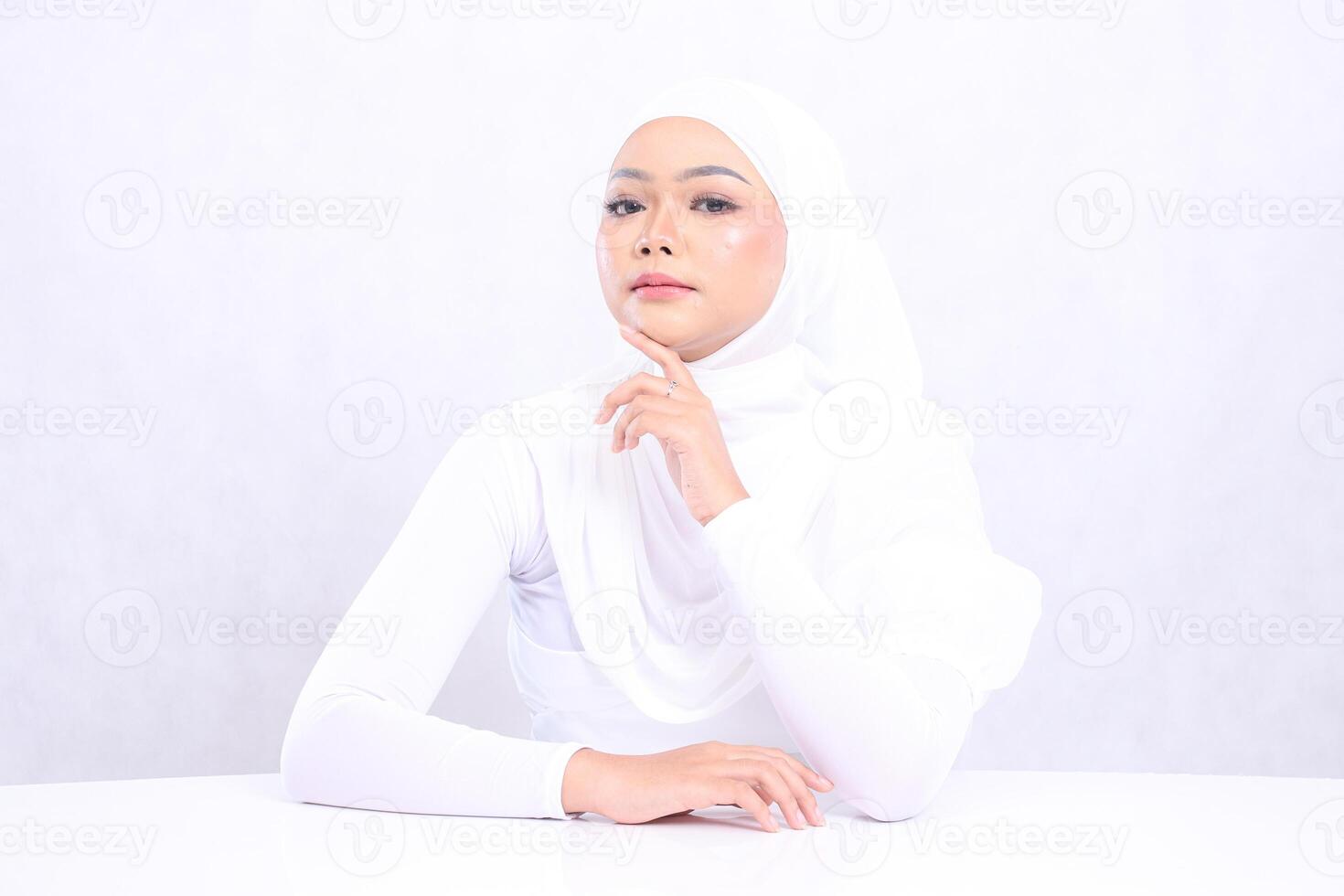 Beauty mature girl focus camera up hand touching chin with bright, glowing and smooth skin color. studio on isolated white background for skin care concept. beauty and health photo