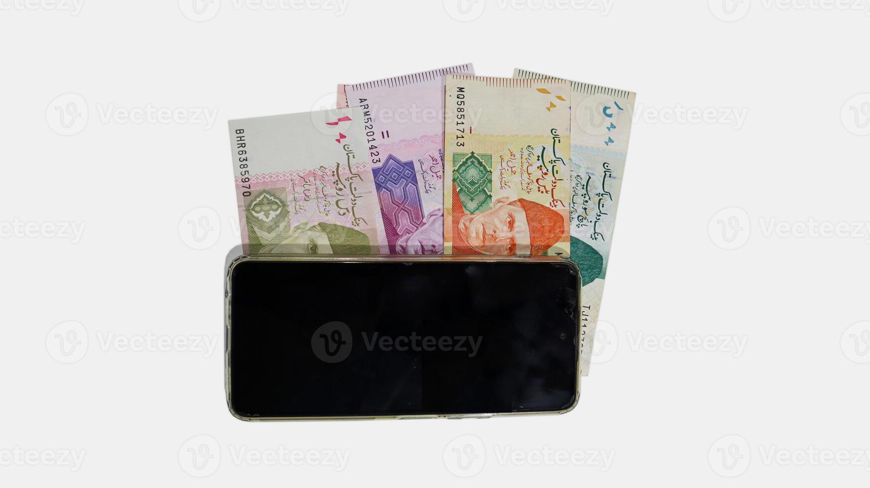Pakistani currency bank notes aligned with mobile phone in sequence 10 20 50 100 500, Pakistan State Bank official currency notes isolated on a white background photo