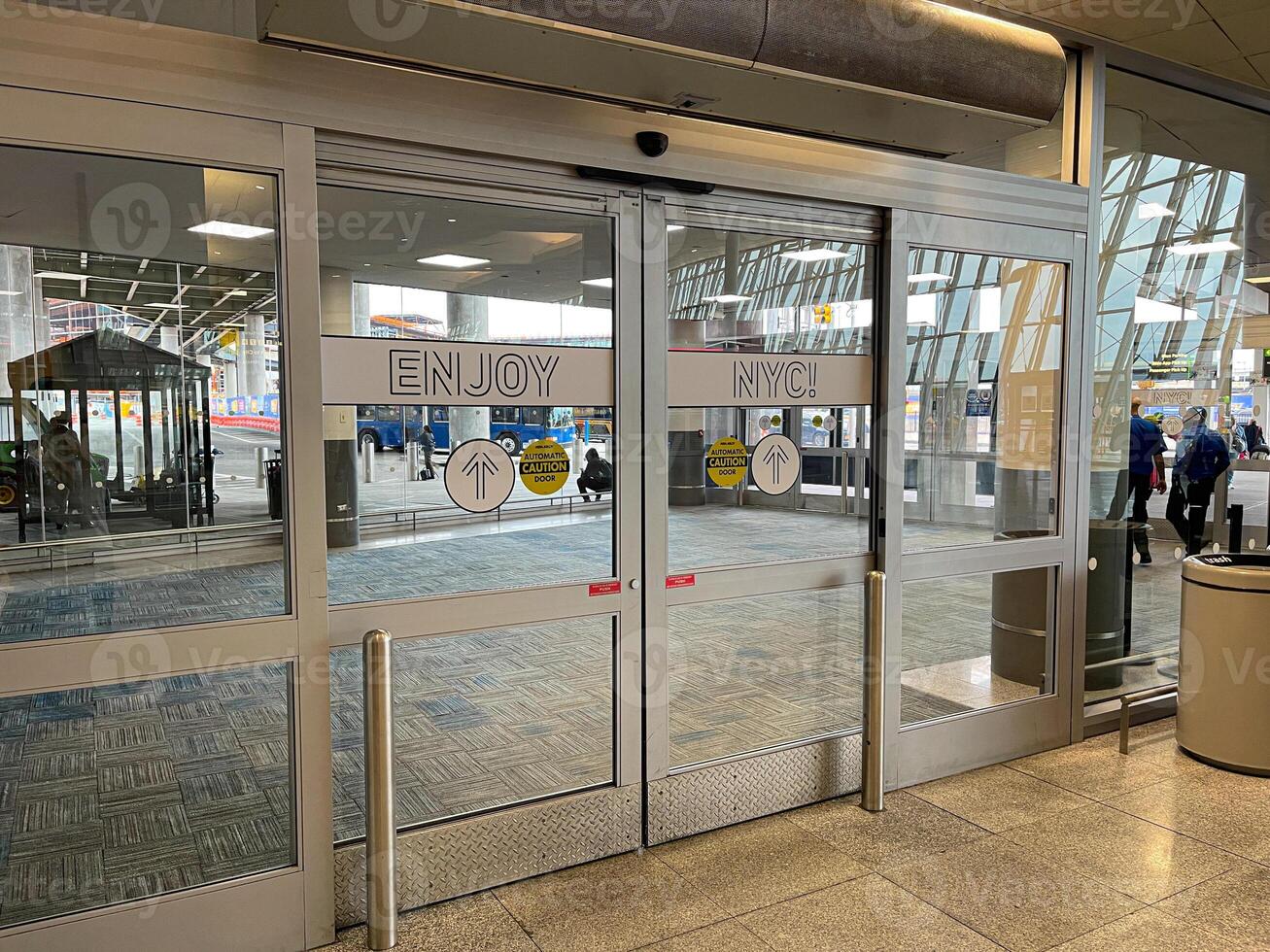 Welcome to New York, glass door from the airport to the city photo