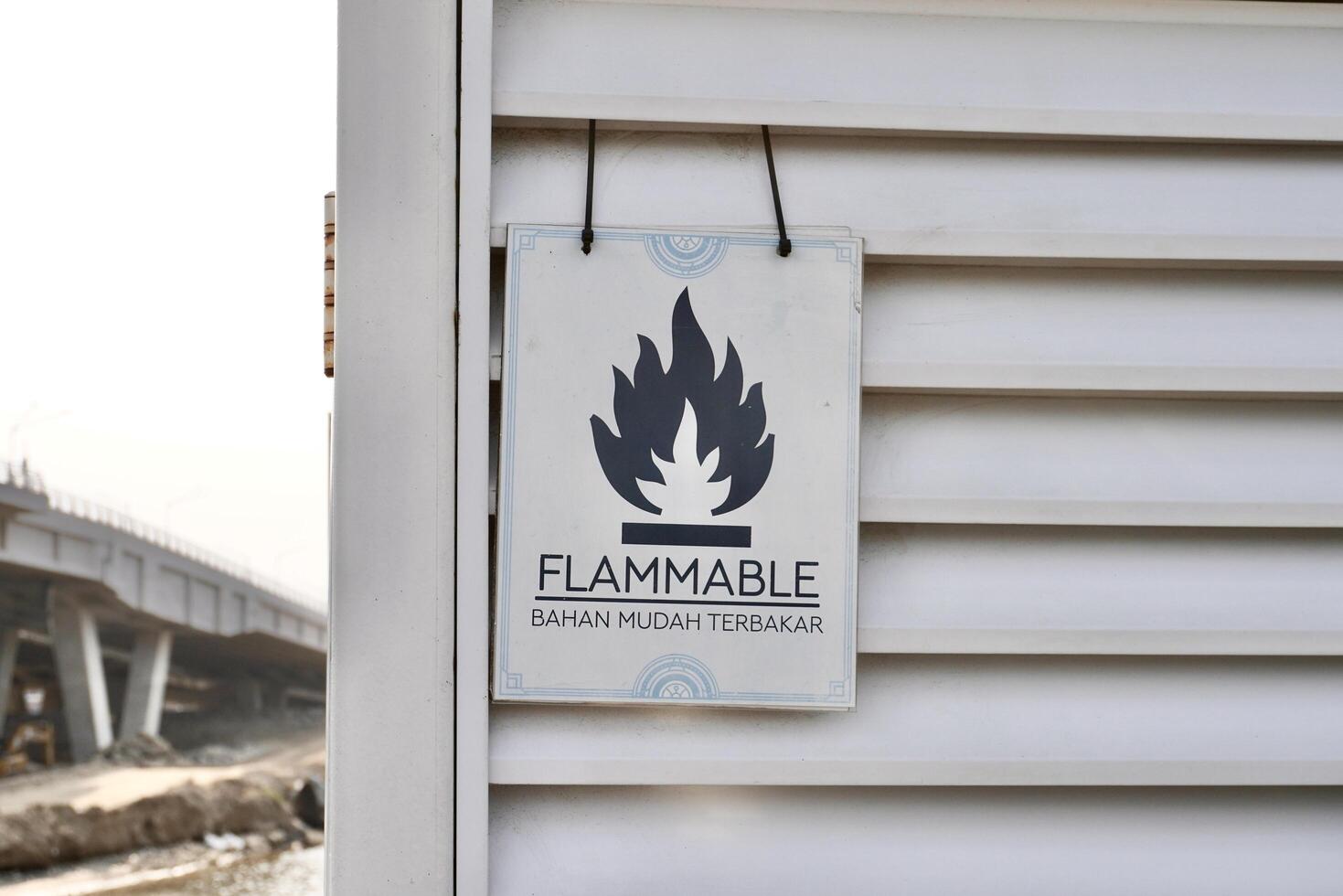 Flammable sign banner isolated on horizontal ratio outdoor white wall background. photo
