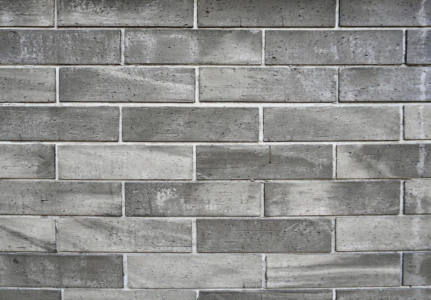 Grungy gray brick wall background building exterior texture material isolated on horizontal ratio background. photo