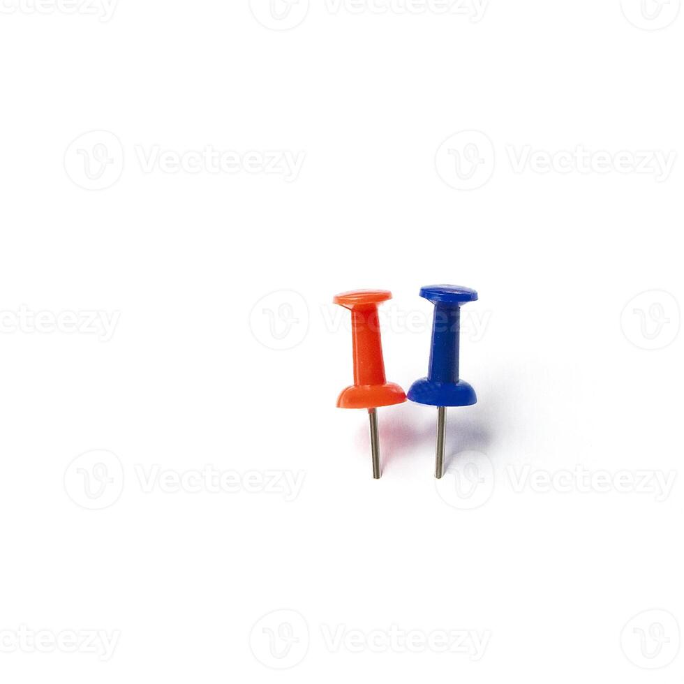 two different colorful push pins isolated on white photo