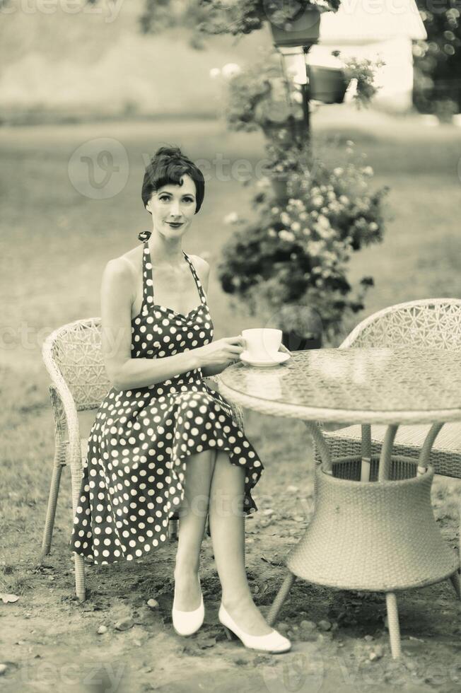 Monochrome portraits with a beautiful woman at a cafe table photo
