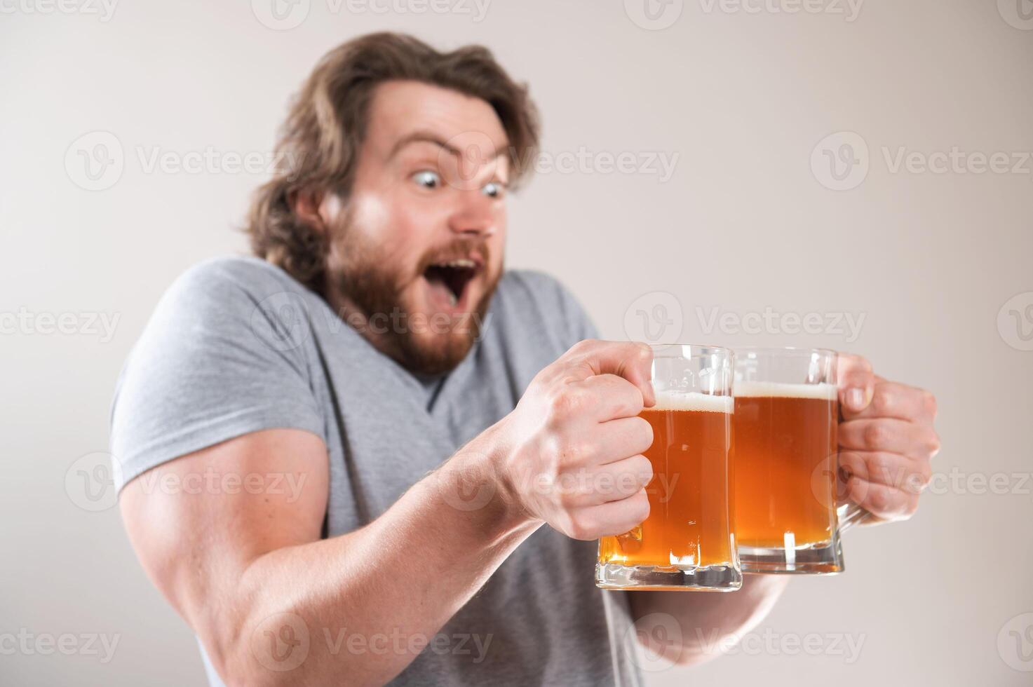 Beer time. Bearded happy man holds beer glass photo