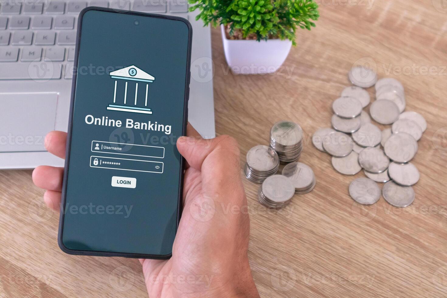 Male hand holding a smartphone to access online mobile banking. Enter username and password to access mobile banking. photo