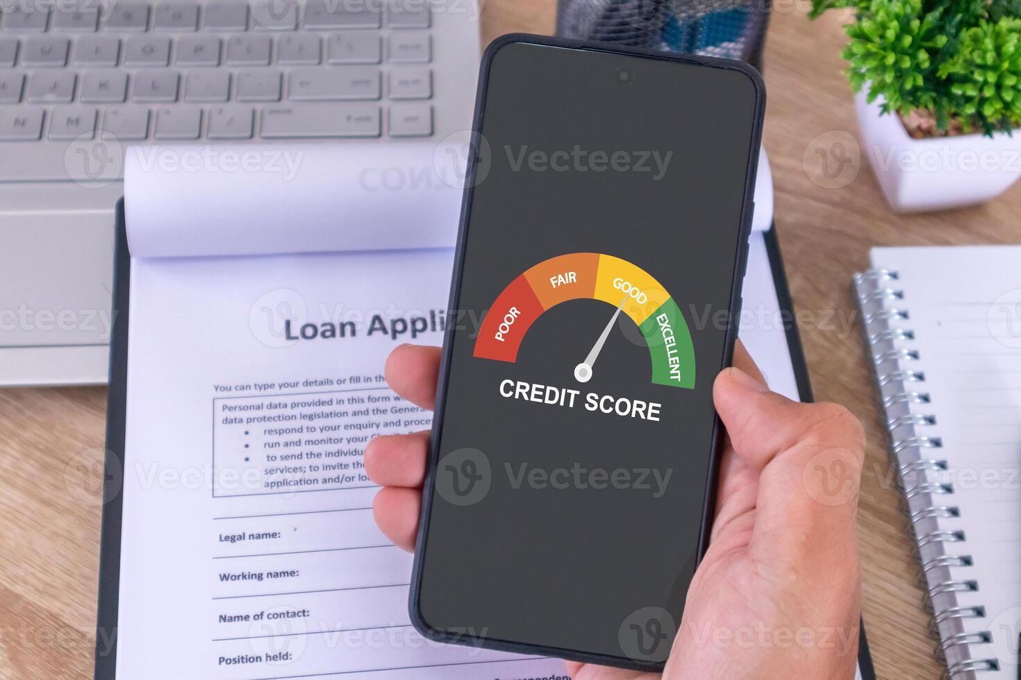 Male hand holding a cellphone to check his credit score to apply for a loan to the bank photo