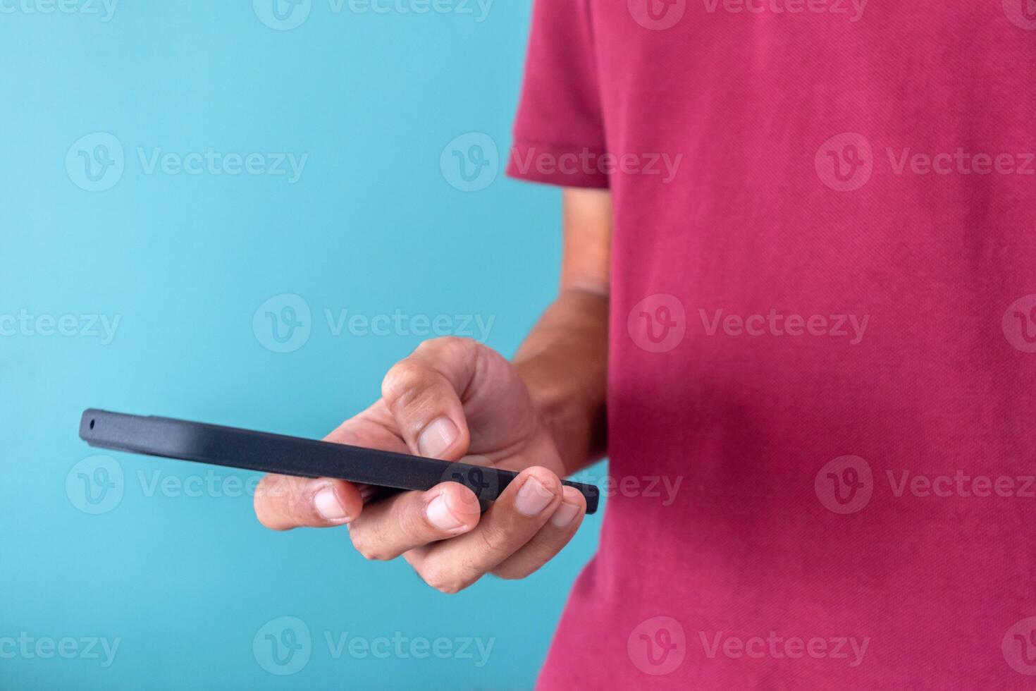 A man uses a mobile phone to search for information or use social media applications photo