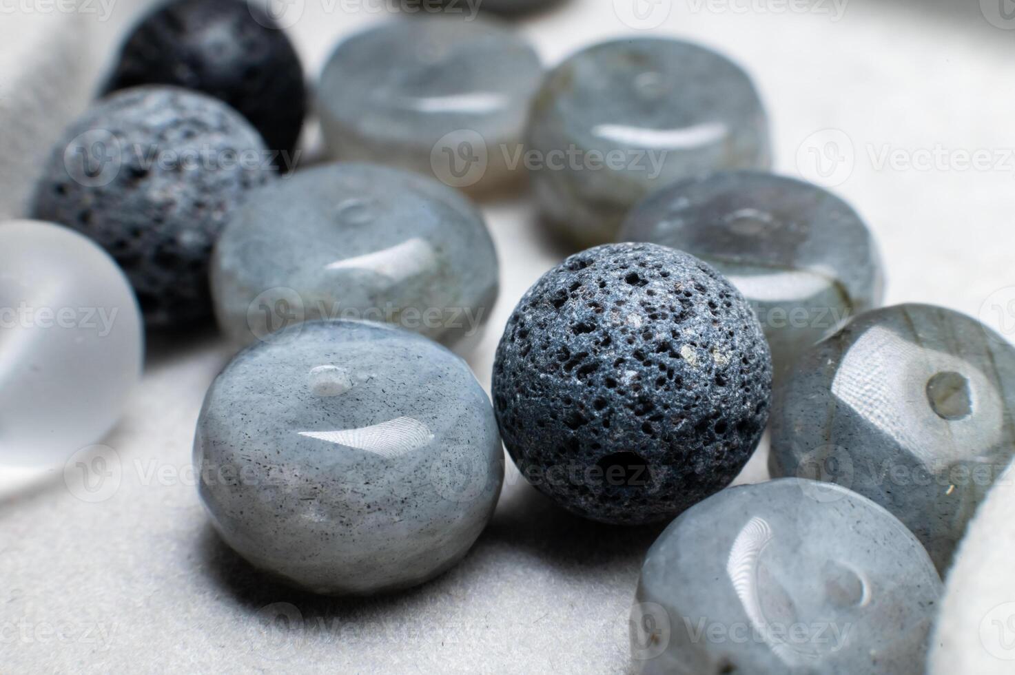 Group of multi-coloured balls made of various natural decorative stones, close-up shot, abstract background photo