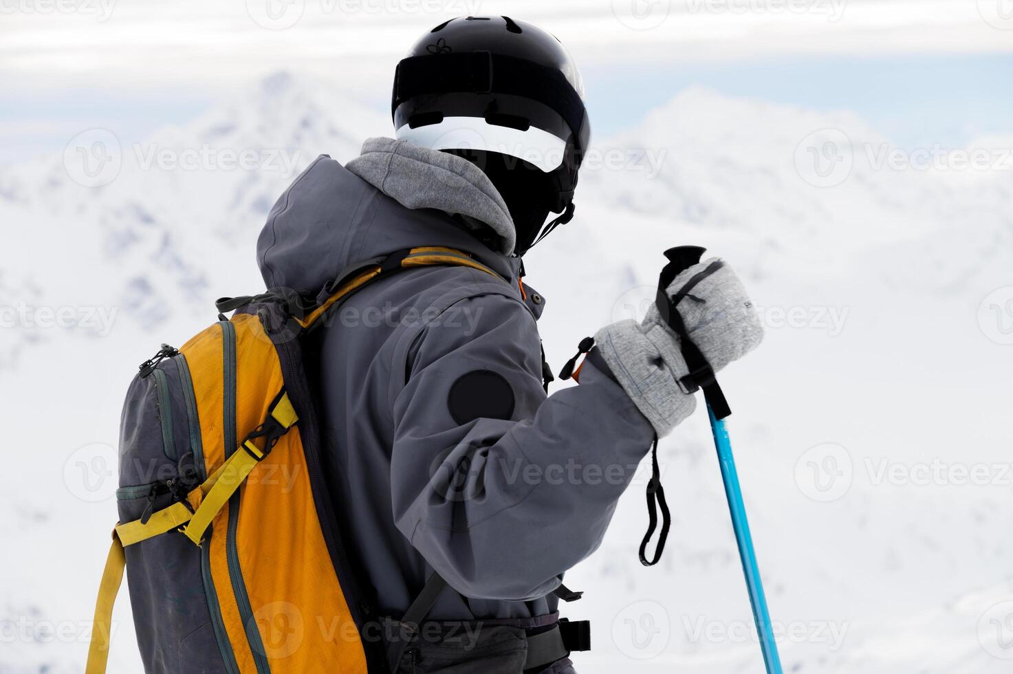 ski background, skier in beautiful mountain landscape, winter holidays in the Alps. unrecognizable person stands with his back to the frame and looks into the distance into the mountain photo