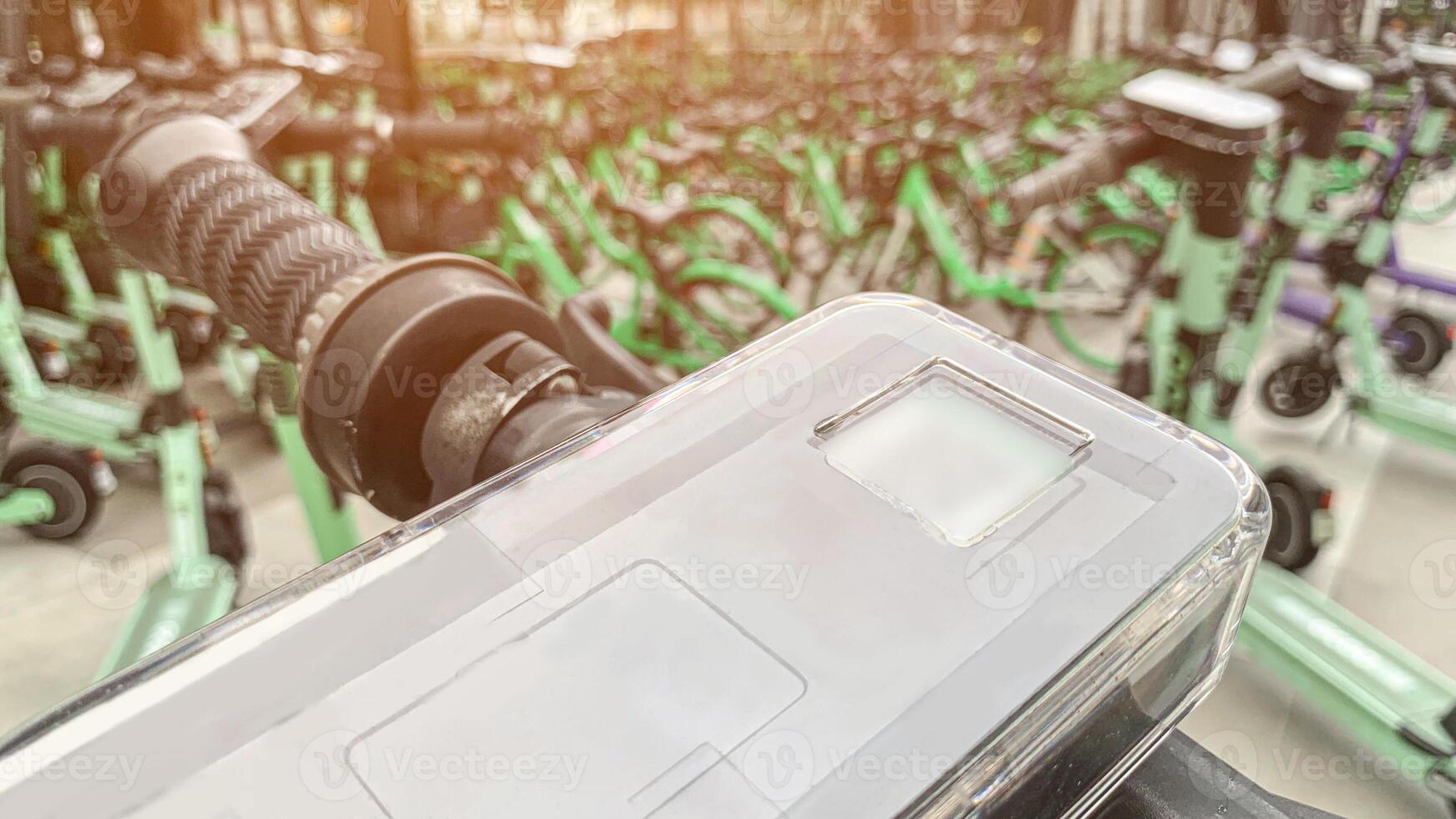 Closeup of Electric Scooter Handlebar with Smartphone Mount, Modern Urban Mobility Solution for Rental Services, Eco-Friendly Commuting, and Sustainable Transportation. photo