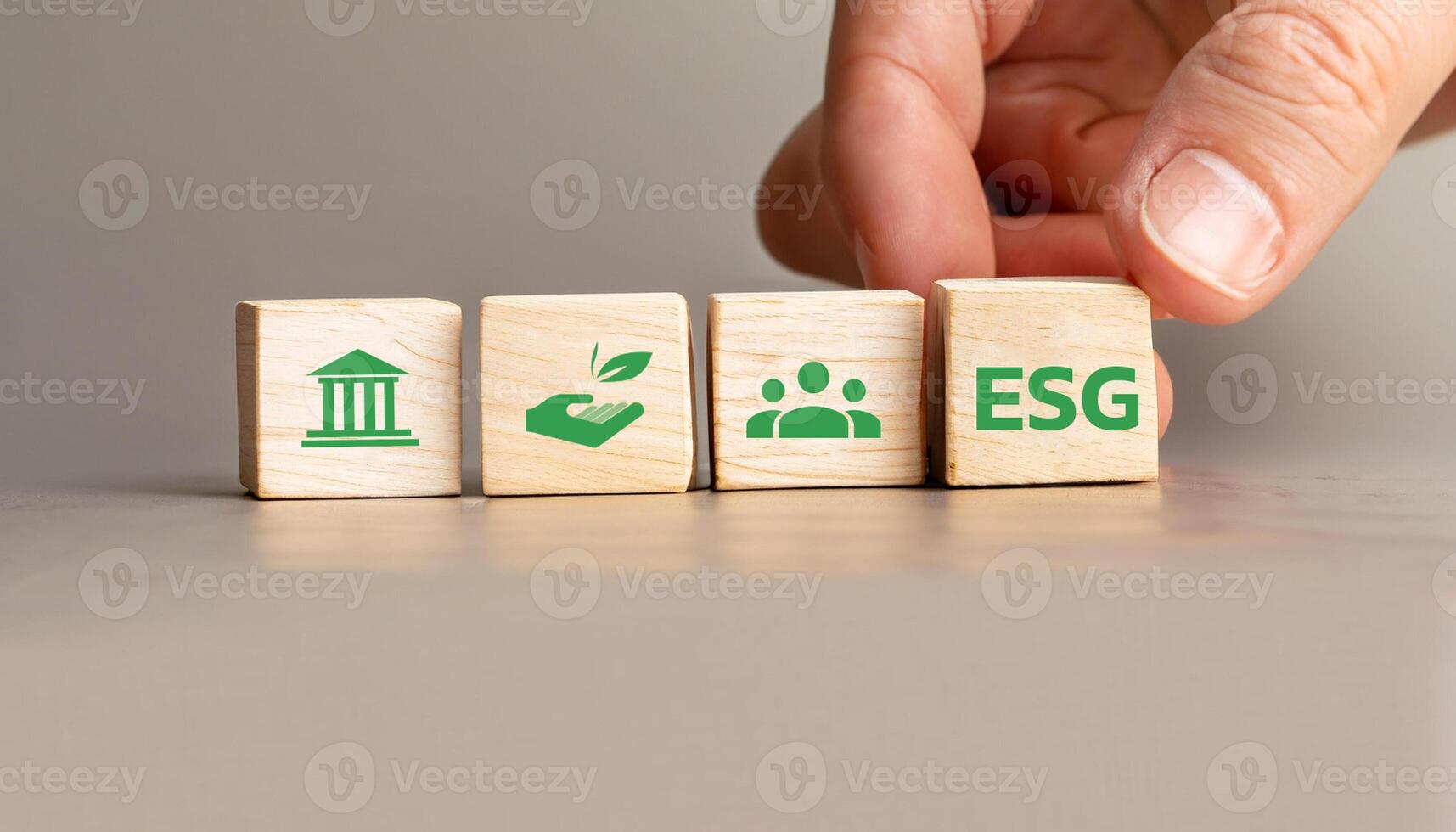 ESG Concept with Wooden Cubes Displaying Environmental, Social, and Governance Icons, Hand Arranging Sustainability Symbols for Corporate Responsibility and Ethical Business Practices. photo