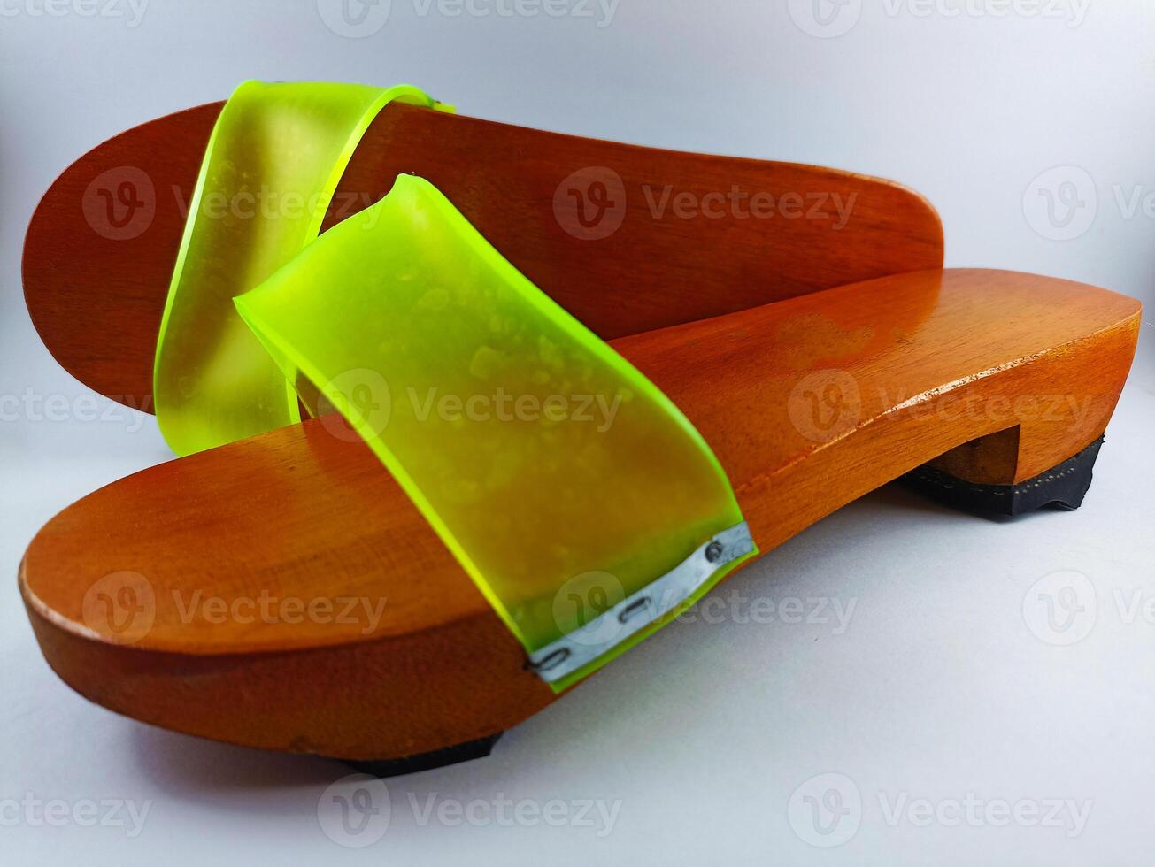 This is a pair of gapyak sandals with a white background. Made from wood, it is a traditional sandal from Indonesia that can be worn by both men and women photo