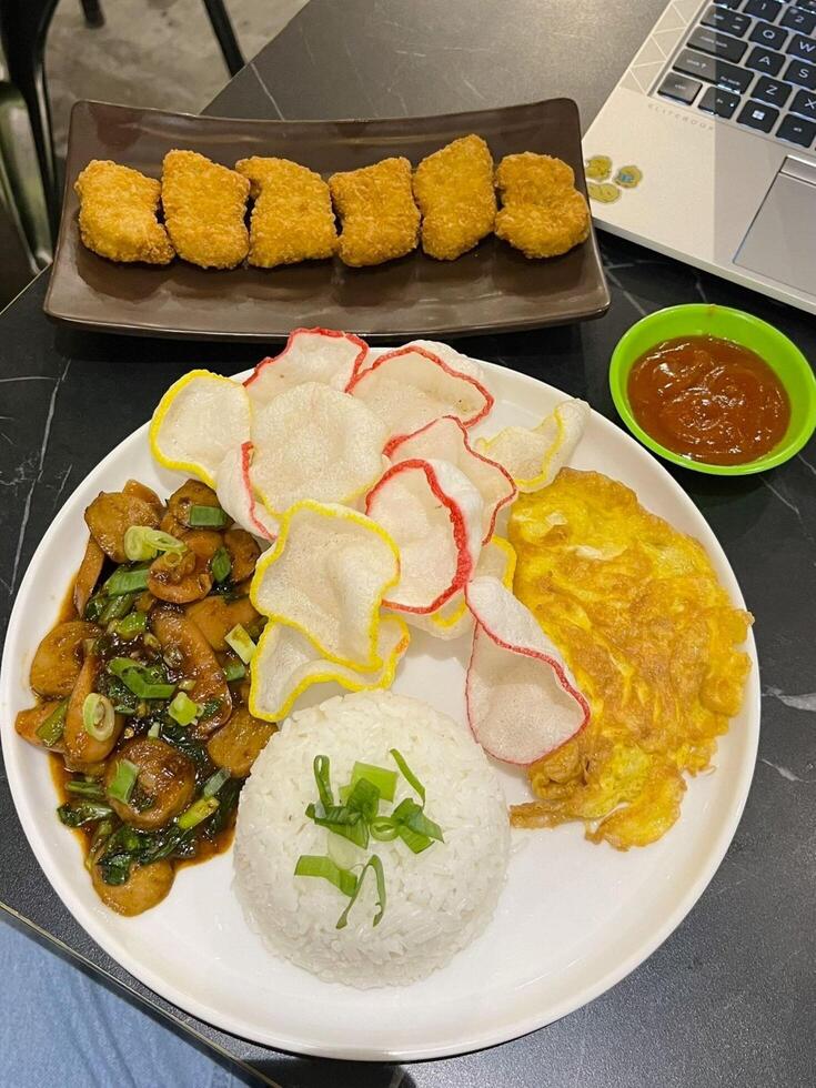 Craving a flavor explosion with Nasi Gila and crispy nuggets. A crazy delicious combo photo
