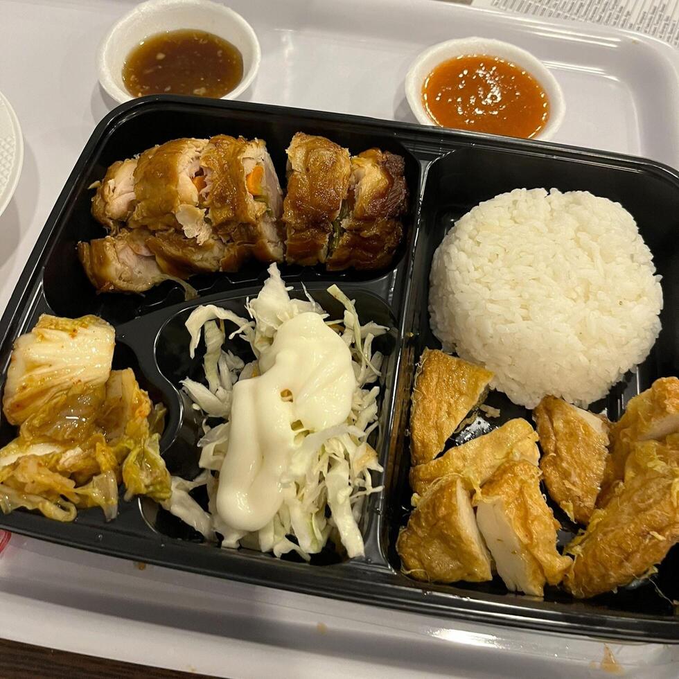 Enjoying this beautiful Japanese bento box, each compartment a delicious surprise photo