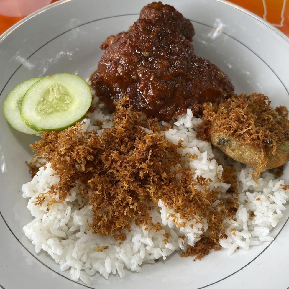 Indulge in a symphony of flavors with Nasi Sambal Ayam Bumbu, aromatic rice paired with tender chicken and a rich, spicy bumbu sauce that tantalizes every taste bud photo