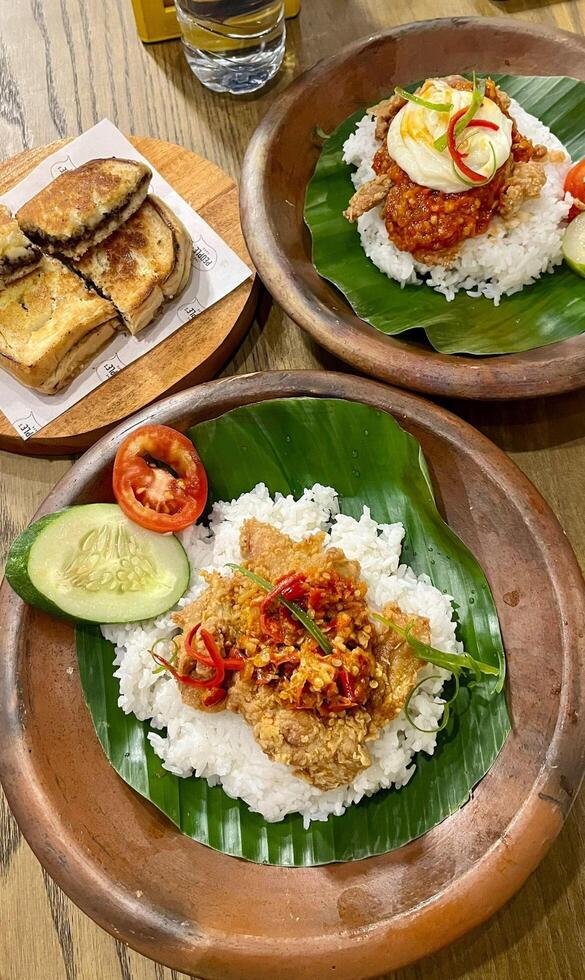 Spicy, crispy, and oh so satisfying. Nasi ayam geprek is the ultimate comfort food that never disappoints. photo