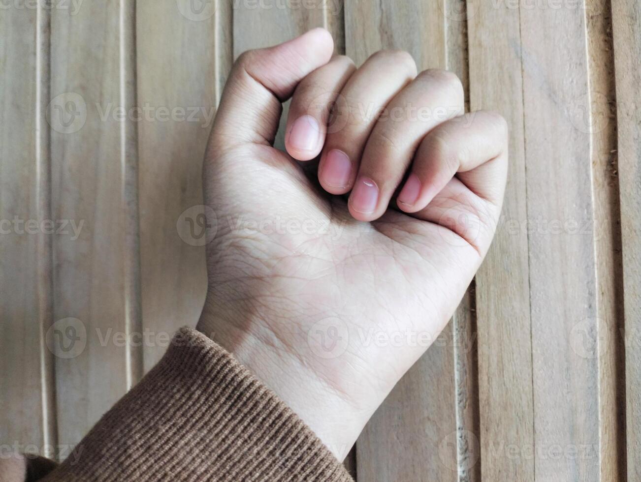 Knocking gesture on a door with wood texture photo