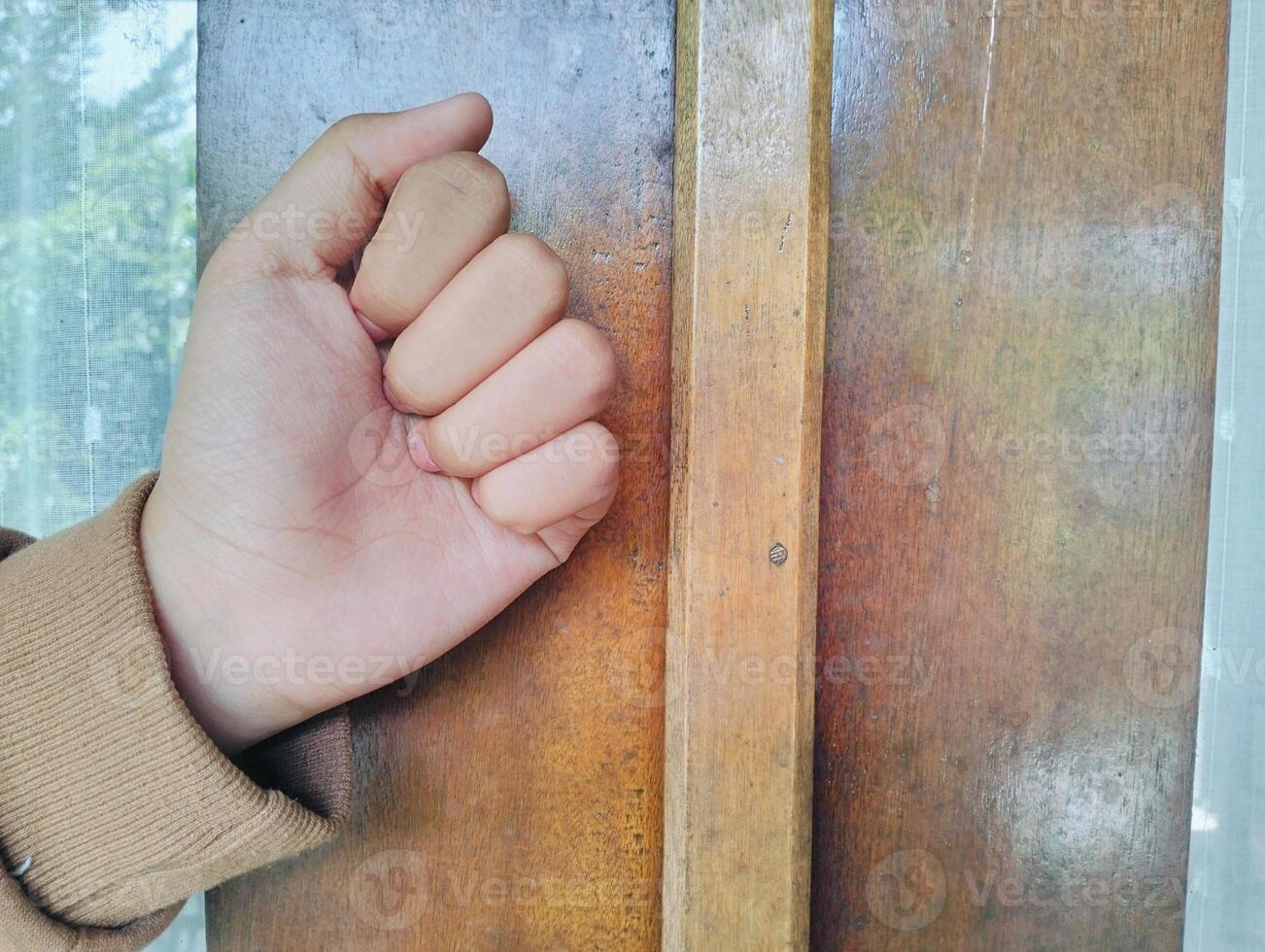 Hand about to knock on wood photo
