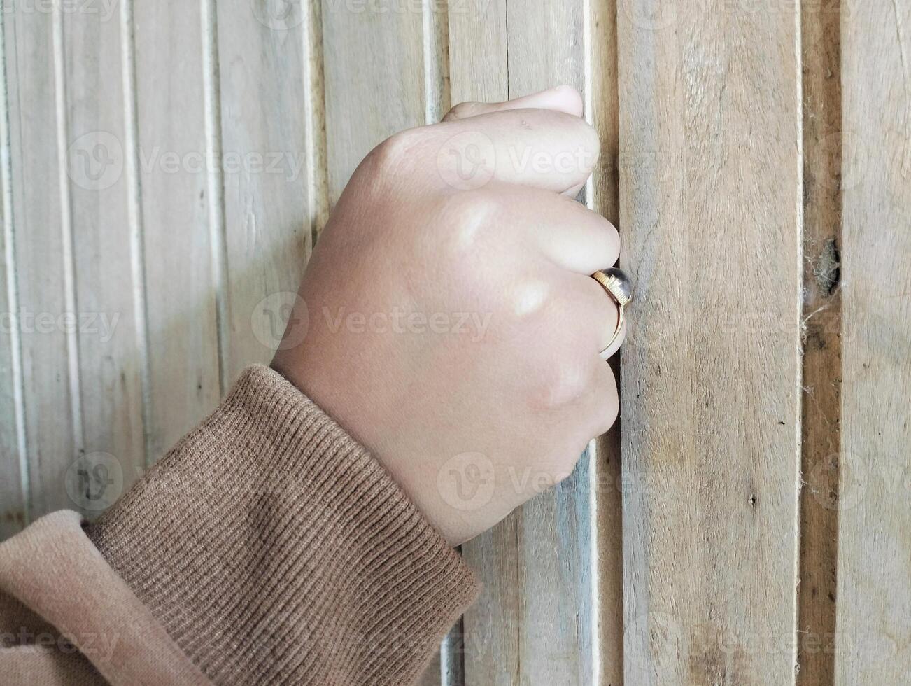 Knocking gesture with fist on door photo