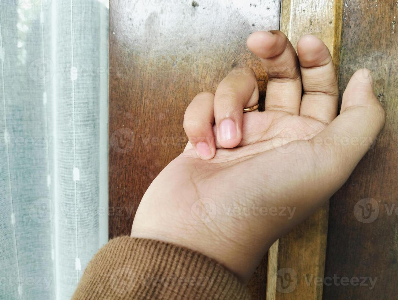 Hand approaching door for knocking photo
