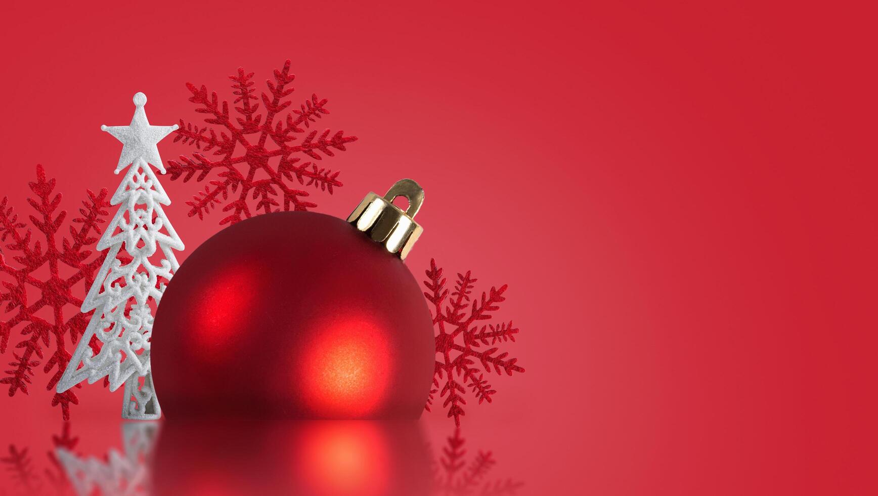 Christmas red ball with a Christmas tree on a red background. Christmas background. Christmas card. photo