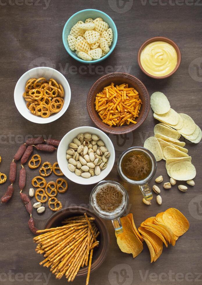 Beer snacks on a wooden table. View from above. Close-up. Copy space. photo