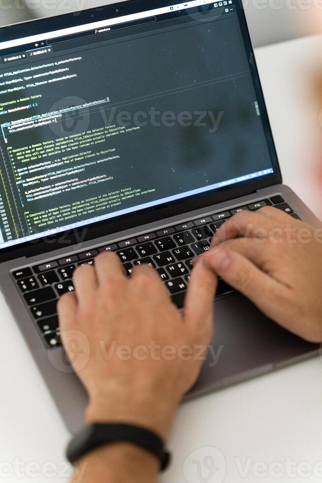 A cropped image of a young man working on a computer. photo