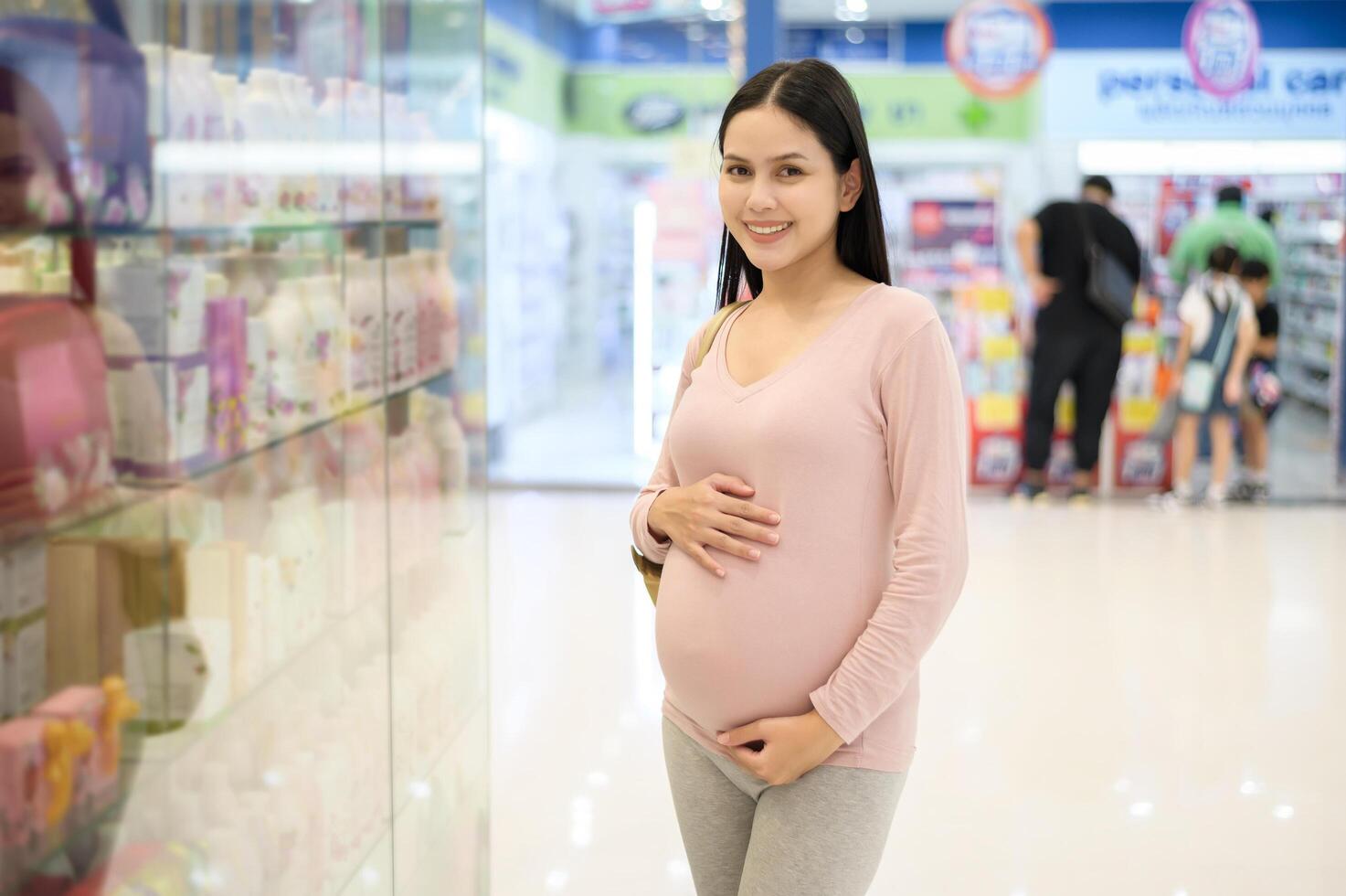 Pregnant woman shopping in the mall center photo