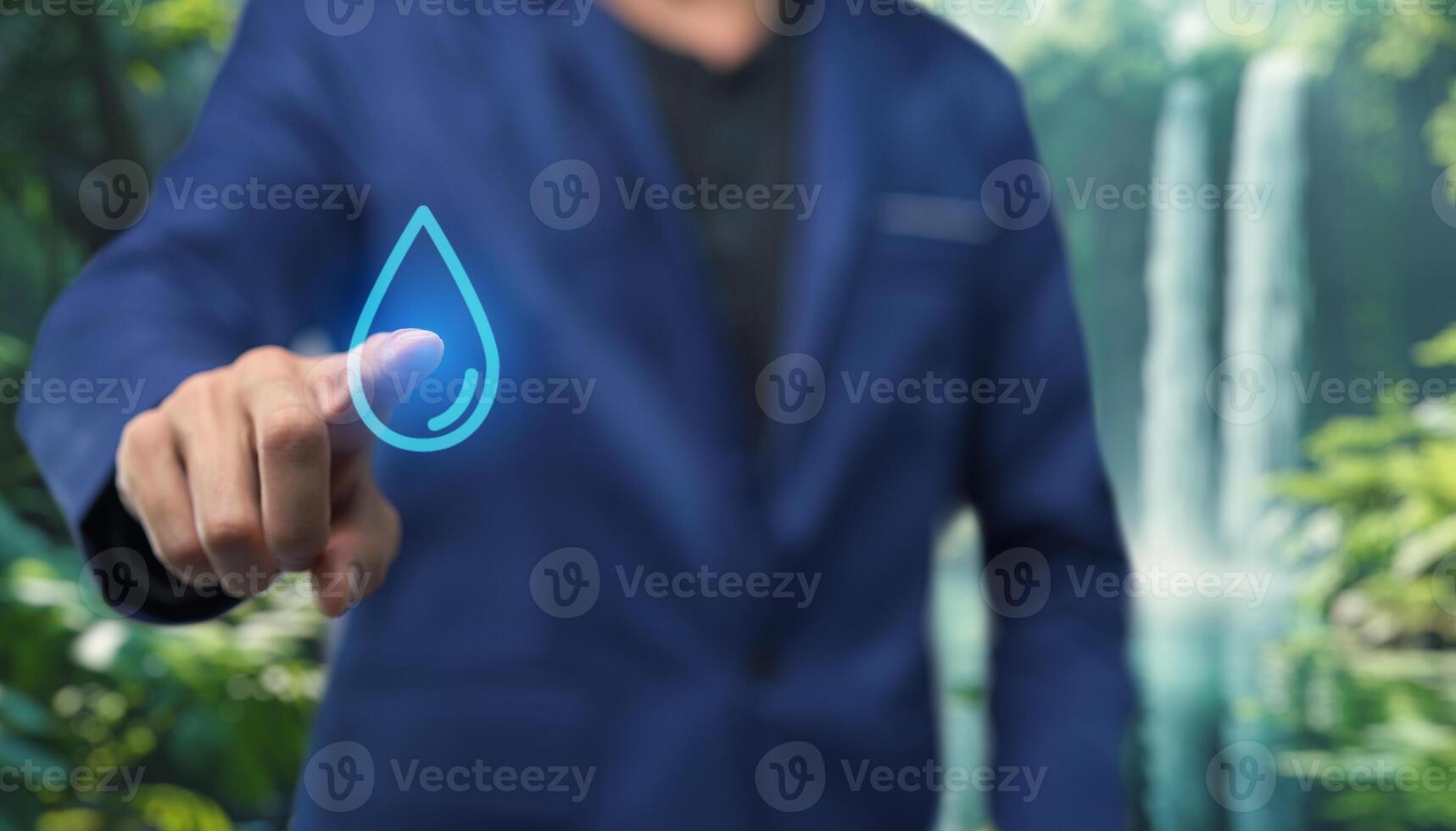 Businessman in suit touching water drop on digital screen photo