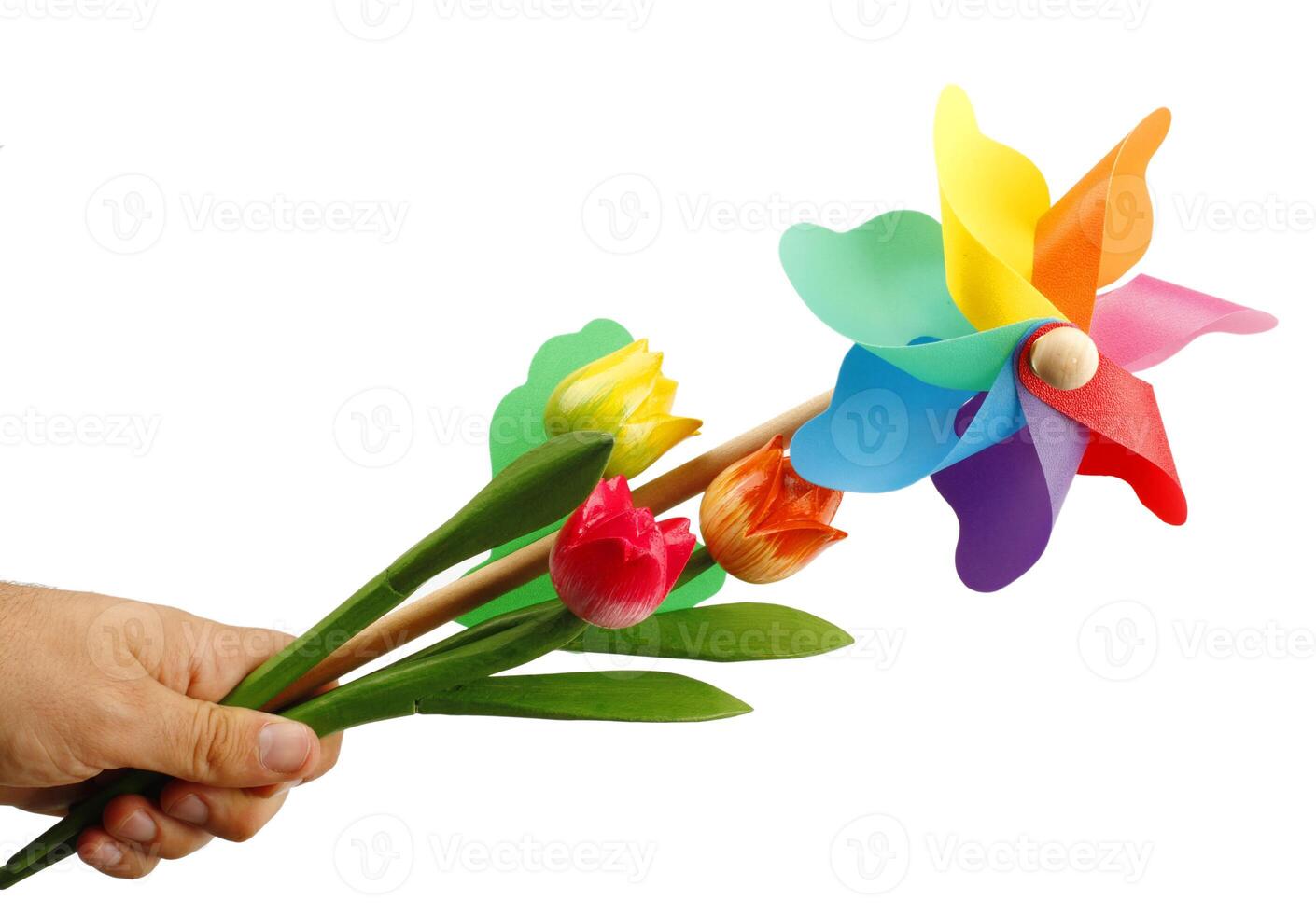 A hand holding a pinwheel with colorful flowers photo
