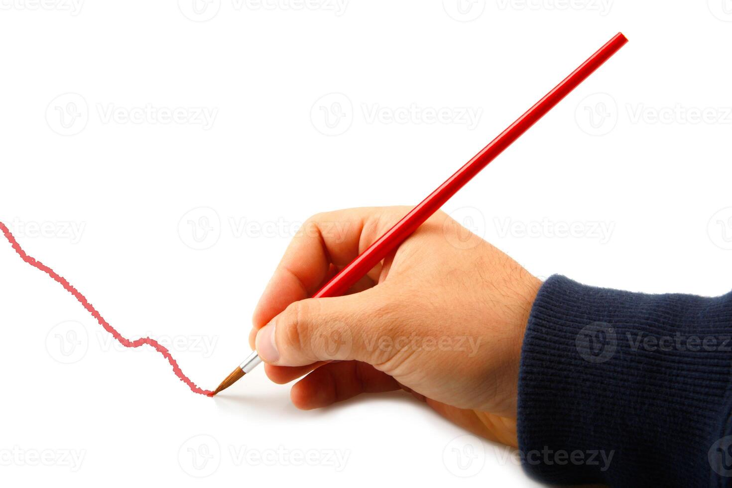 A person is drawing a line with a red pencil photo