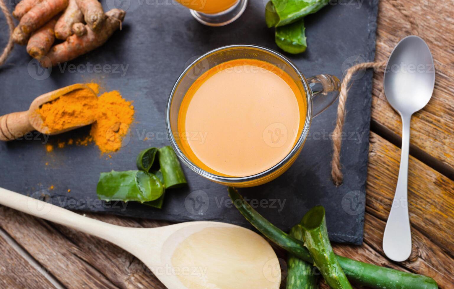 Turmeric and ginger tea on a wooden table photo