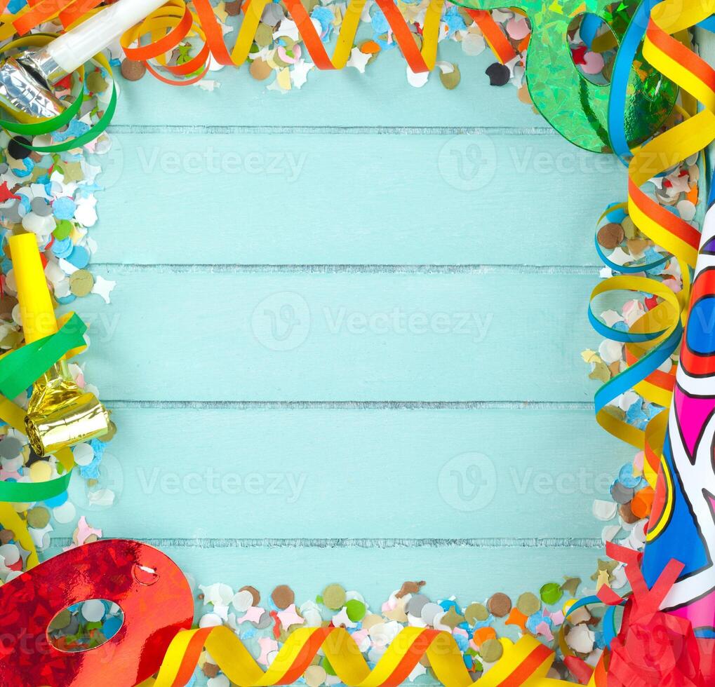 A blue background with colorful confetti and party supplies photo