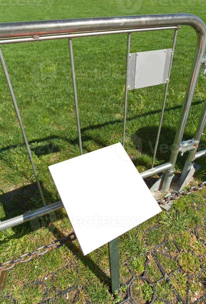 A white square on a metal fence photo
