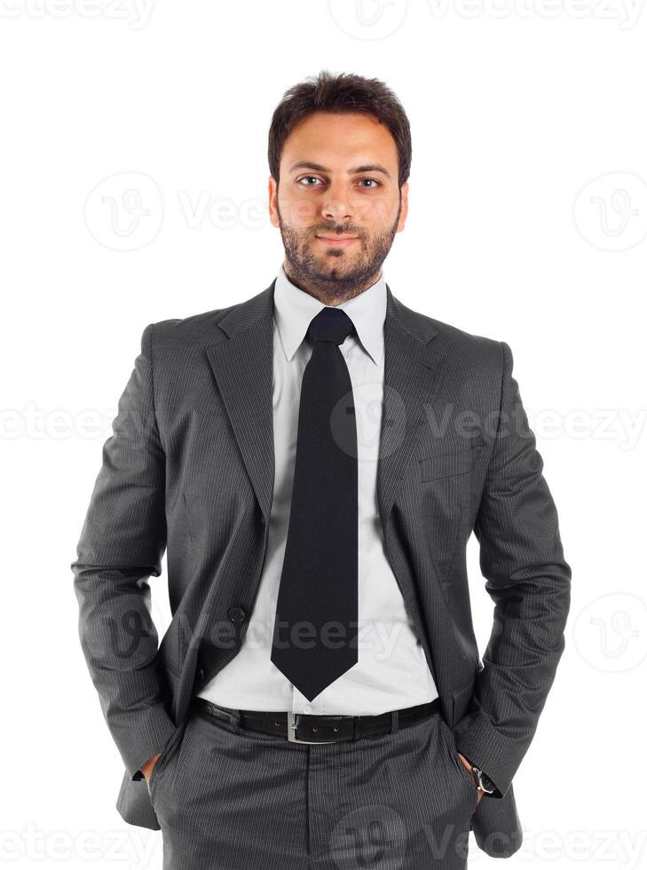 A man in a suit and tie standing with his hands on his hips photo