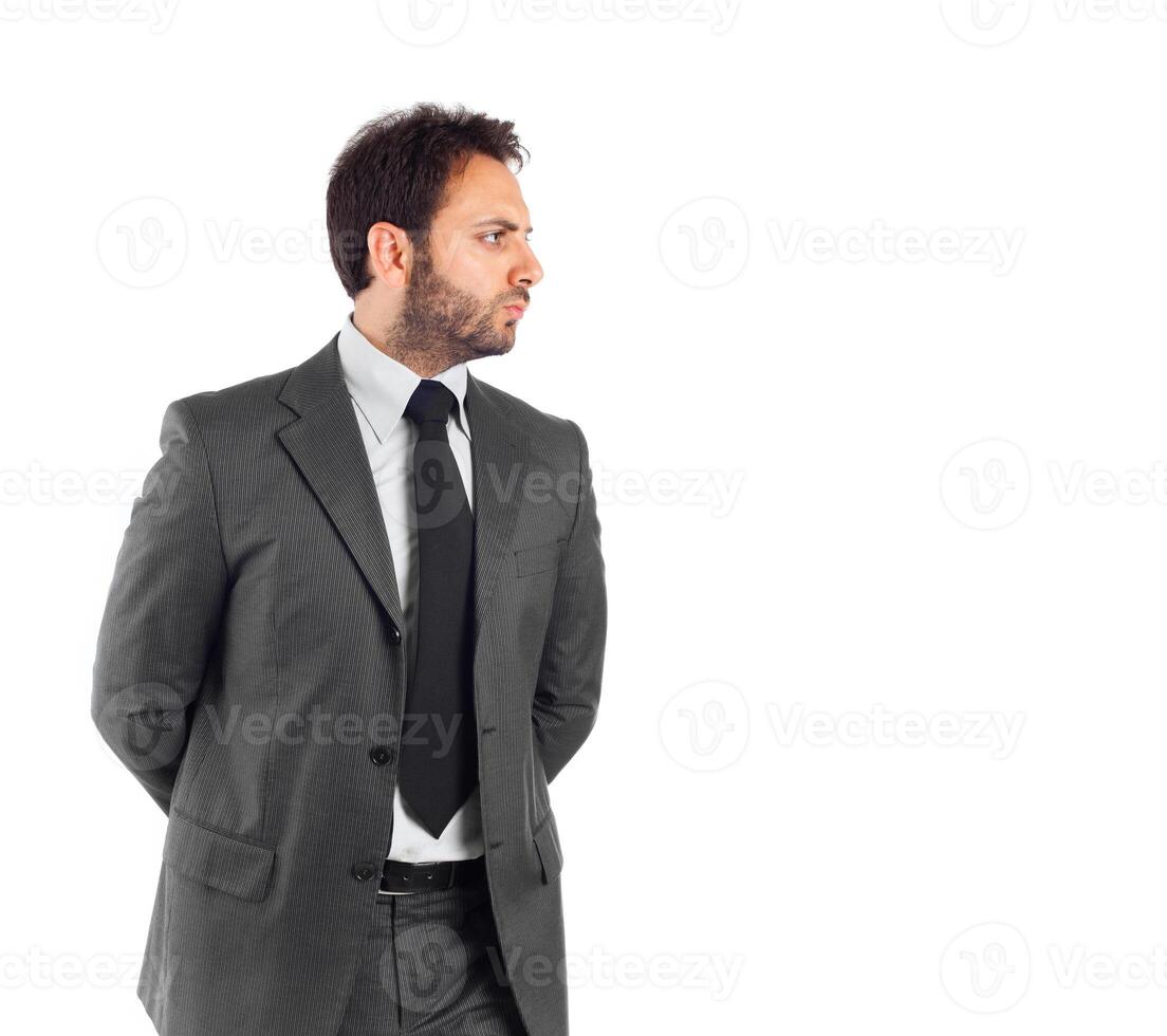 A man in a suit standing with his hands on his hips photo