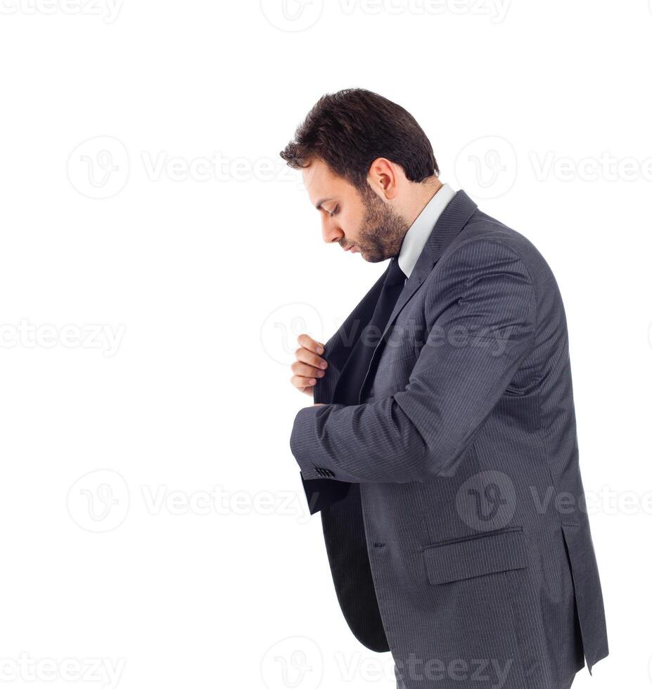 A man in a suit adjusting his jacket photo