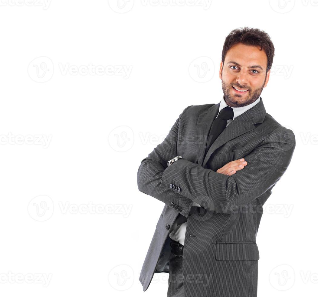 A man in a suit and tie standing with his arms crossed photo