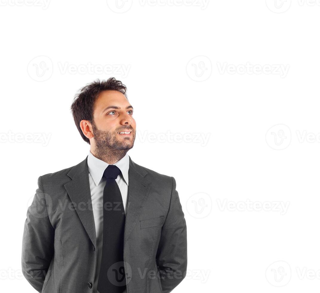 A man in a suit and tie standing with his arms up photo