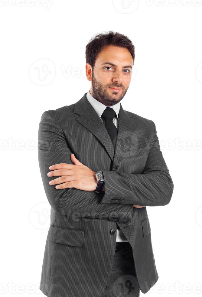 A man in a suit and tie standing with his arms crossed photo