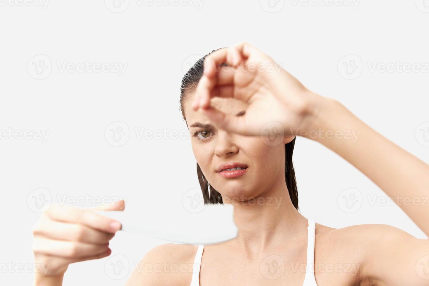 Disappointed woman holding a test result, displaying a negative reaction The clean white background photo