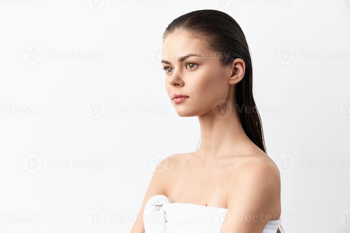 Elegant portrait of a young woman with straight hair and a calm, composed demeanor, set against a photo